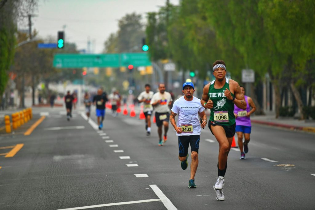 a group of people running down a street