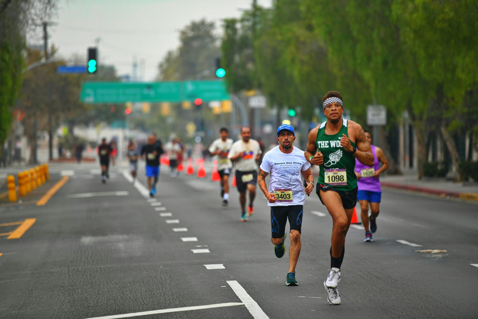 a group of people running down a street